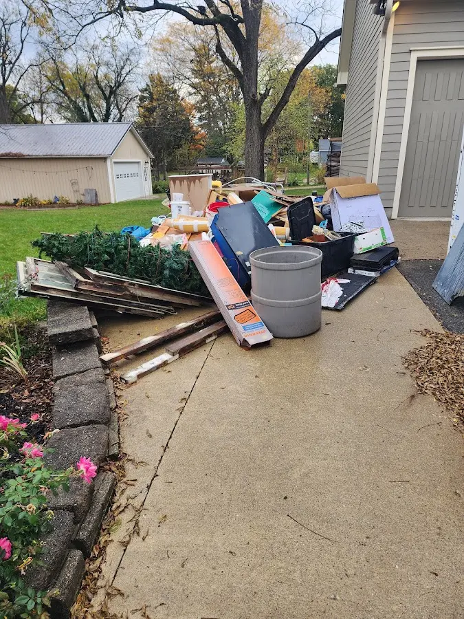 Dumpster being loaded with debris for 12 Yard Dumpster Rental in Danville